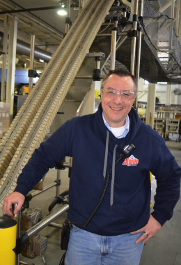 Moosehead Breweries reliability specialist Frank Beneteau stands beside the Bosch Rexroth VarioFlow incline conveyor system used to move the bottle production line up and out of the way at the New Brunswick headquarters facility.