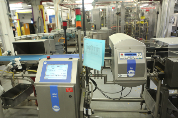 After passing through a LOMA Systems IQ3 metal detection system, product passed over an LCW 3000 checkweigher, with reject packs blown into a cavity (left) for an additional quality check by plant food safety inspectors.