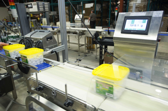 A Multiweigh checkweigher installed by RJP Packaging verifies the weight of plastic tubs used to package larger quantities of detergent pods preferred by Big Box retail customers.