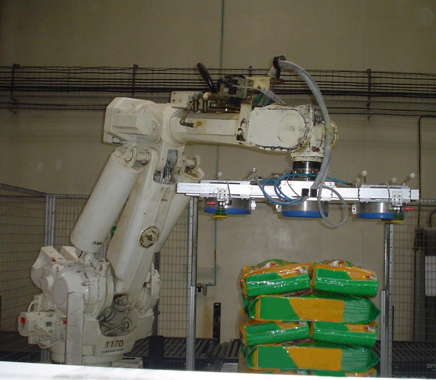 The obligatory BEFORE photo: the customer’s former vacuum EOAT deformed the center of each bag, making it impossible to stack pallets efficiently.