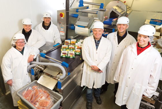 Standing beside the Reiser Repak RE15 thermoformer is the Gibiers Canabec fondue department team (from left): Michèle, Diane and Yves, production manager Richard Desrosiers, CEO Alexandre Therrien, and operations manager Marie-Pier Cote.