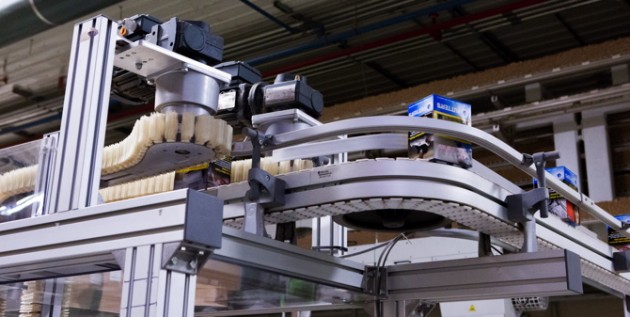 The outfeed of a wedge elevator conveyor from FlexLink quickly and safely move cartons of cigarettes to a cartoner in another part of the facility without damaging the exterior face of the brand1s packaging.