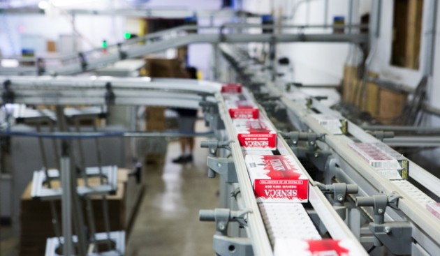 Grand River Enterprises utilizes a high-speed X85 wedge elevating conveying system with bends, manufactured by FlexLink Systems Canada to move cartons of tobacco products.