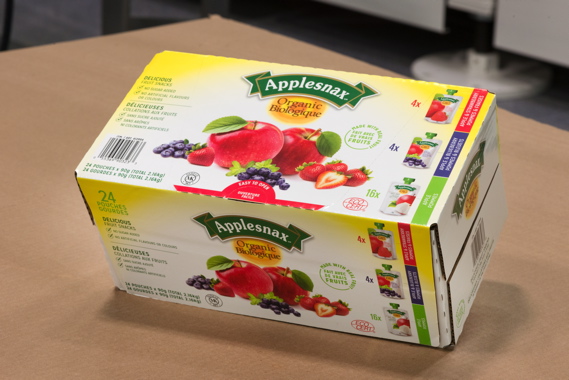 A 24-pack of Applesnax Organic applesauce pouches packaged inside a colorful pre-printed corrugated case produced by Norampac, a division of leading Canadian forest products group Cascades Canada Inc.