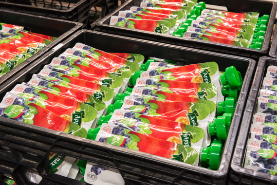 Finished plastic pouches of Leahy Orchards’ Applesnax brand of applesauce await to be packed into corrugated 24-packs at the apple processor’s production facility.
