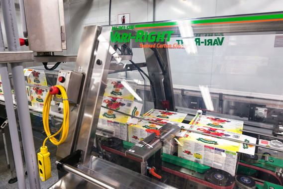 Integrated into the production line by StrongPoint Automation, a Kliklok Vari-Right top-load carton closer is used at Leahy Orchards to seal 24-packs of its own Applesnax Organic brand of 90-gram applesauce pouches.