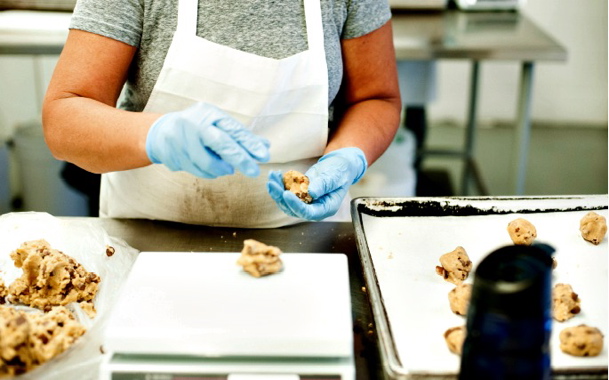 Each and every cookie produced at the Cookie It Up facility is formed and shaped by hand by one of several line operators from the freshly-mixed slabs of dough (above left) blended to right consistency on a nearby Hobart mixer.