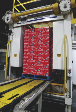 A fully-stacked 21-layer pallet-load of canned cases emerges from a T-Tek palletizer to make its way to a nearby ITW Muller stretchwrapper to secure the load into place to ensure optimal product safety during transport.