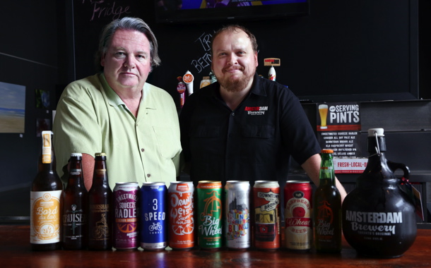 Amsterdam Brewing Company owner Jeff Carefoote (left) and brewmaster Iain Mc-Oustra show off some of the company’s premium-quality products and different packaging formats at the retail storefront at the entrance to the company’s 65,000-square-foot brewery located in Toronto’s trendy Leaside neighborhood.