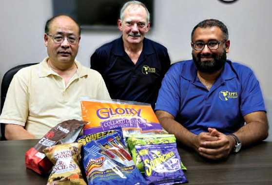 From Left: APPE team members displaying some of the flexible packaging produced on the Vertobagger 2.0 machine include mechanical engineer Winston Lu, national service manager Bob LeClair, and national sales manager Al Aman.