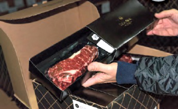 The thermoformed vacuum-packs of the Selection 1913 brand of AAA- and Prime-graded beef are inserted inside individual decorative gift-boxes prior to being packed inside the shipping containers.