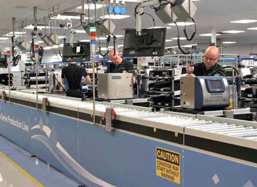 Domino Printing Sciences employees at the company’s manufacturing facility in Cambridge, U.K., assembling the new Ax-Series line continuous inkjet coding systems, which were officially launched worldwide earlier this month as a replacement for the older A-Series CIJ coders to provide manufacturing end-users with much more reliable, user-friendlier and higher-quality printing of barcodes, text, logos and other machine-readable variable product information required for today’s demanding product traceability initiatives and complex supply chain operations.